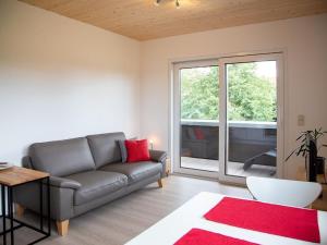 a living room with a couch and a large window at Apartment im Illertal by Interhome in Altenstadt