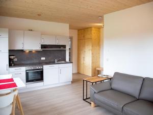 a living room with a couch and a kitchen at Apartment im Illertal by Interhome in Altenstadt