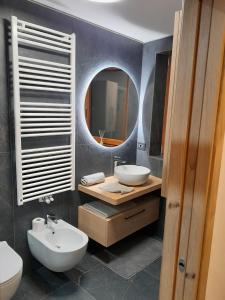 a bathroom with a sink and a mirror at Casa Zena in Tesero +17 photos