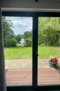 a sliding glass door with a view of a yard at Apartment am Wurlsee by Interhome in Lychen