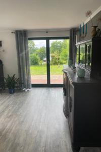 an empty living room with a large glass door at Apartment am Wurlsee by Interhome in Lychen