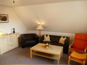 a living room with a couch and a table at Apartment Schwalbenring by Interhome in Rövershagen