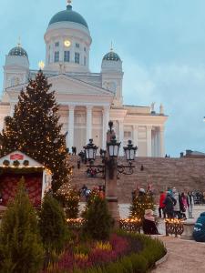 a christmas tree in front of a large building at Aikatalo Hostel Helsinki in Helsinki