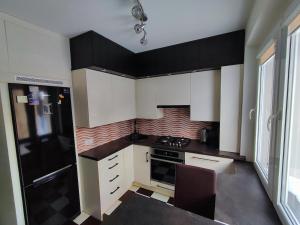 una cucina con mobili bianchi e un forno a piano cottura di Three-room apartment a Venta