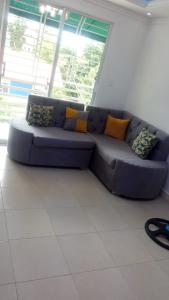 a blue couch in a room with a window at Alojamiento M&M in Los Paredones +1 photo