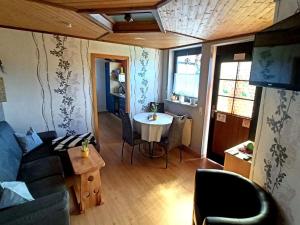 a living room with a couch and a table at Apartment Haus-Trapp by Interhome in Unterbernhards +11 photos