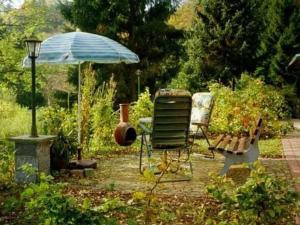 a patio with a chair and an umbrella at Holiday Home mit Bergblick by Interhome in Ilfeld +5 photos