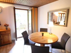 a dining room with a table and chairs and a mirror at Apartment Bemer-Rempfler by Interhome in Bürglen