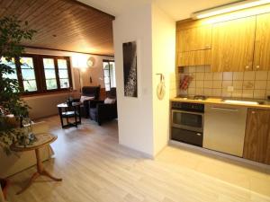 a kitchen and living room with a stove and a table at Apartment Bemer-Rempfler by Interhome in Bürglen +13 photos
