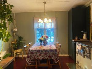 a dining room with a table with flowers on it at Atelier Torppa in Rovaniemi