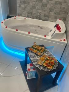 a bath tub with a table in front of it at B&B A Da Ziett Suite in Naples