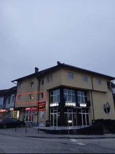 a large building on the corner of a street at KRUNA Apartment in Cazin