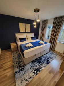 a bedroom with a bed with two towels on it at KRUNA Apartment in Cazin