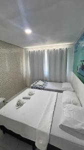 En eller flere senge i et værelse på pousada agua viva