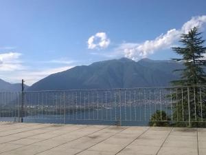 a fence with a view of a mountain at Apartment Casa Barbara by Interhome in Piazzogna