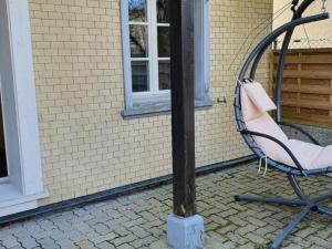 a chair sitting next to a lamp post at Apartment GLORIOS by Interhome in Heiden