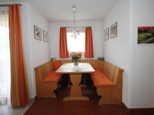 a dining room table with a vase of flowers on it at Apartment Aivla by Interhome in Celerina +9 photos