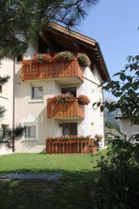 a building with flower boxes on the side of it at Apartment Aivla by Interhome in Celerina