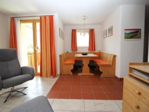 a living room with a table and a chair at Apartment Aivla by Interhome in Celerina