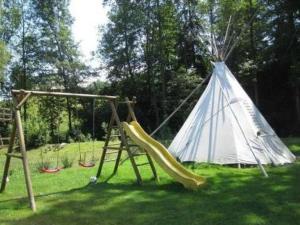 a playground with a slide and a teepee at Apartment Farbhaus Bleiche by Interhome in Rohrbach