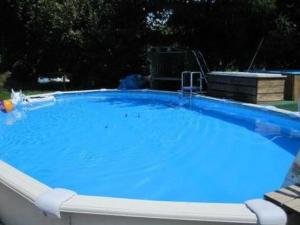 a large pool with blue water in a yard at Apartment Farbhaus Bleiche by Interhome in Rohrbach