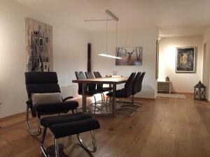a dining room with a table and chairs at Apartment Chäserruggblick by Interhome in Unterwasser