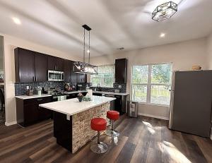 a kitchen with a large island in the middle at River Side Private Retreat in Seguin