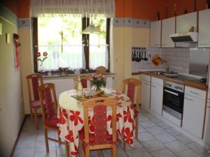 a kitchen with a table and chairs and a kitchen with a table at Apartment im Teutoburger Wald by Interhome in Schieder