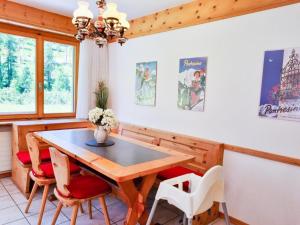 a dining room with a wooden table and chairs at Apartment Curtins16 by Interhome in Pontresina