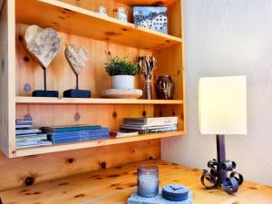 a book shelf with a lamp on a desk at Apartment Curtins16 by Interhome in Pontresina +25 photos