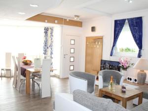 a living room with a couch and chairs and a table at Apartment Vulkaneifel by Interhome in Daun