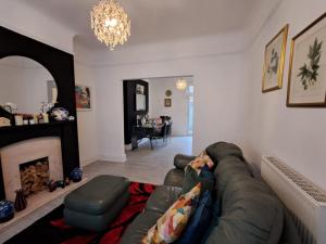 a living room with a couch and a fireplace at 16 Skipton Road in Liverpool