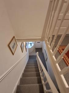 a stairway in a house with white walls and stairs at 16 Skipton Road in Liverpool