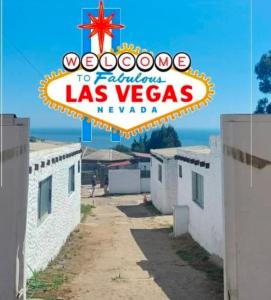 a sign for the las vegas sign on top of buildings at Cabañas las vegas in San Antonio