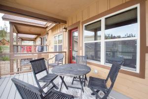 a patio with a table and chairs on a porch at Rendezvous 47 Lookout Point in Fraser