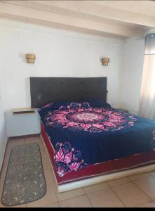 a bedroom with a large bed with a blue comforter at Cabañas las vegas in San Antonio