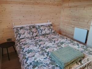 a bedroom with a bed in a wooden room at Stag's View in Ballina