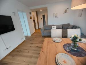 a living room with a couch and a table at SeeZeitApartments Whg 27 in Lembruch