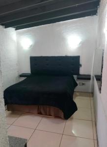 a bedroom with a green bed in a room at Cabañas las vegas in San Antonio