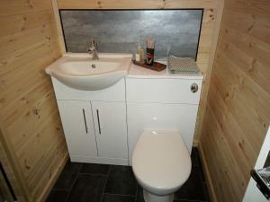 a small bathroom with a sink and a toilet at Stag's View in Ballina