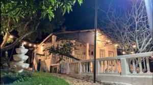 a house with a porch at night with lights at Recanto Cravo & Canela in Meruoca