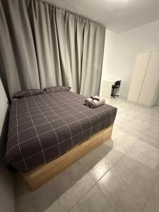 een slaapkamer met een bed met een bruine geruite deken bij Onlyroom Madrid Calatrava in Madrid