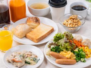 a table topped with plates of food and drinks at APA Hotel Asakusa Kuramae in Tokyo