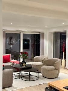 a living room with two couches and a table at Nordic Panorama in Tromsø