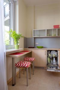a kitchen area with a table and chairs at Apartamenty Media Park in Warsaw