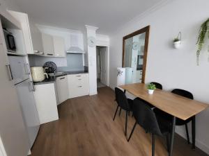 a kitchen and dining room with a table and chairs at Remblai des Sables d'Olonne - 2 chambres - parking et piscine in Les Sables-d'Olonne