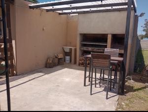 un patio con tavolo, sedie e un pianoforte di Casa con parque para 5 personas a Miramar Altre 3 foto