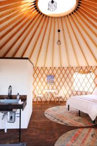 een kamer met een bed en een wastafel in een yurt bij Johnny Yurts in Johnson City