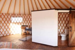 a room with a white door in a yurt at Johnny Yurts in Johnson City