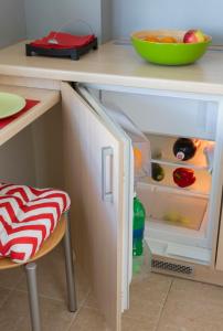 a kitchen with a refrigerator and a cupboard at Apartamenty Media Park in Warsaw